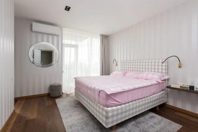Stock reference: a bright bedroom with soft colours and fitted storage.