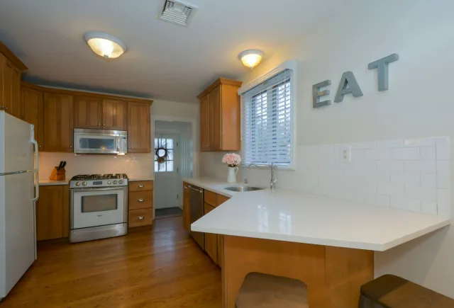Stock reference: a kitchen with wooden cabinets and light work surfaces.