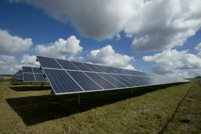 Solar panels installed in rows beneath an open sky