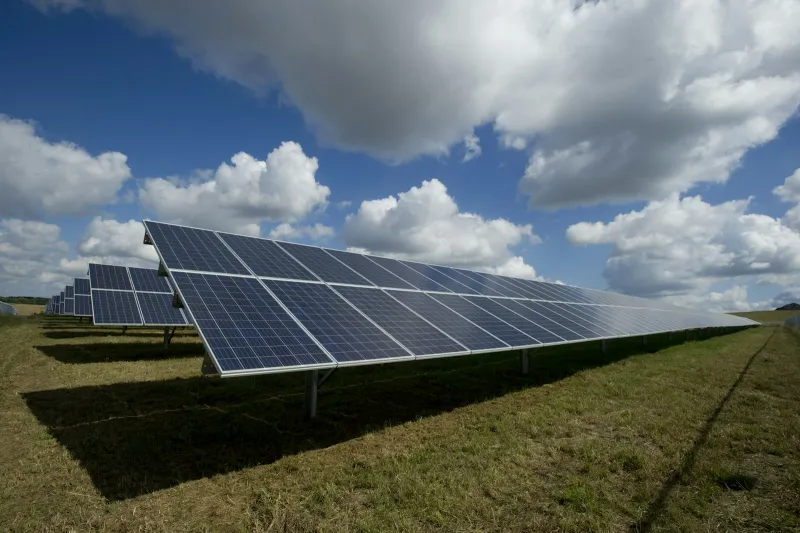 Stock reference: ground-mounted solar panels in an open landscape.